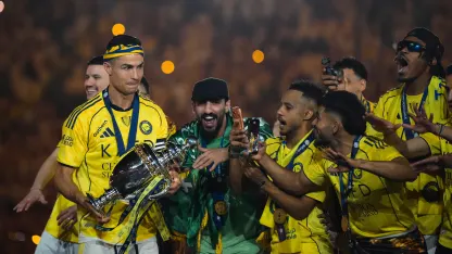 Cristiano Ronaldo carries the long-awaited RSL trophy to his Al Nassr teammates