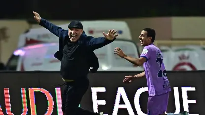 Al Kholood manager Noureddine Ben Zekri celebrates sealing survival v Al Fayha