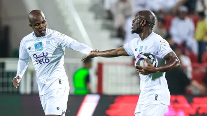 Knowledge Musona (L) celebrates goal for Al Okhdood v Damac