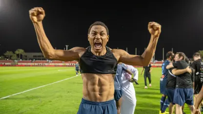 Leandre Tawamba celebrates Al Okhdood survival