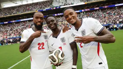 Ivan Toney (L) celebrates England's bronze at FIFA World Cup after France win
