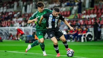 Gabri Veiga (L) and Cristian Guanca contest the ball in Al Ahli v Al Shabab