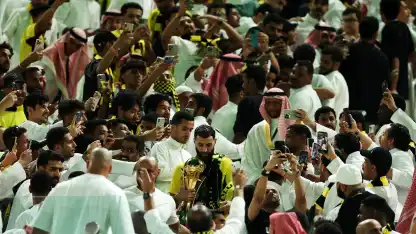 Karim Benzema with King's Cup trophy among the Al Ittihad fans