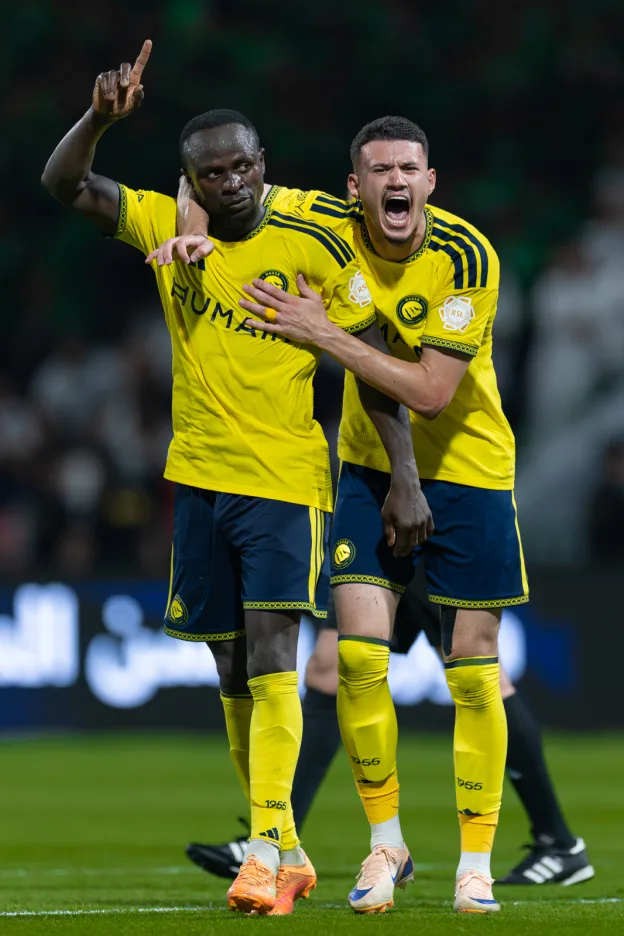 Abdullah Al Hamdan celebrates with goalscorer Sadio Mane as Al Nassr come back to defeat Al Ettifaq